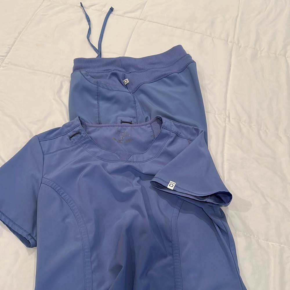 Pair of ceil blue scrubs, medium top and large bottom. See pictures for flaws.